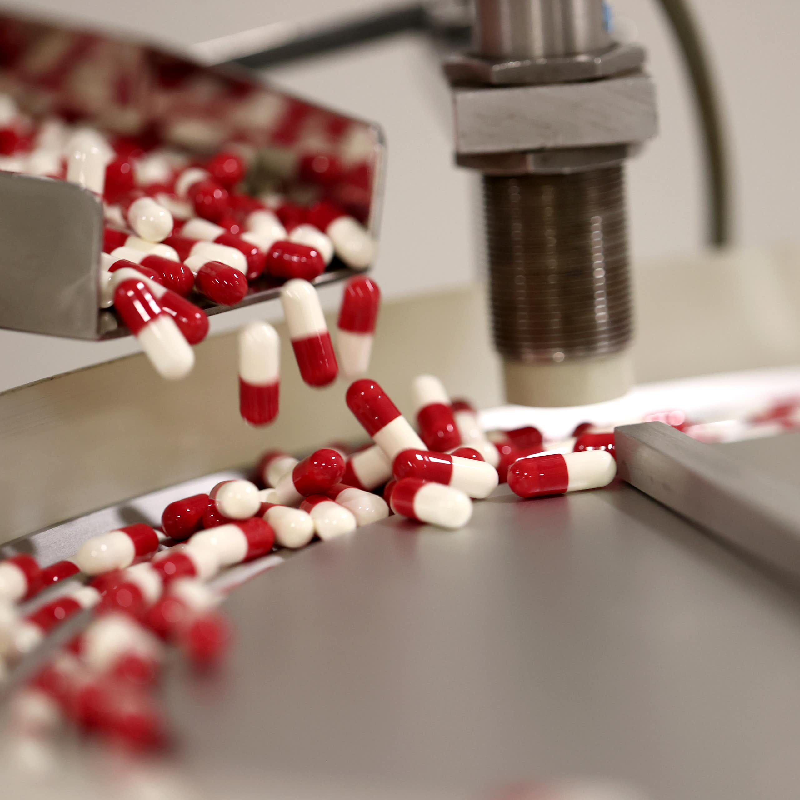 Red and white capsules in a production line