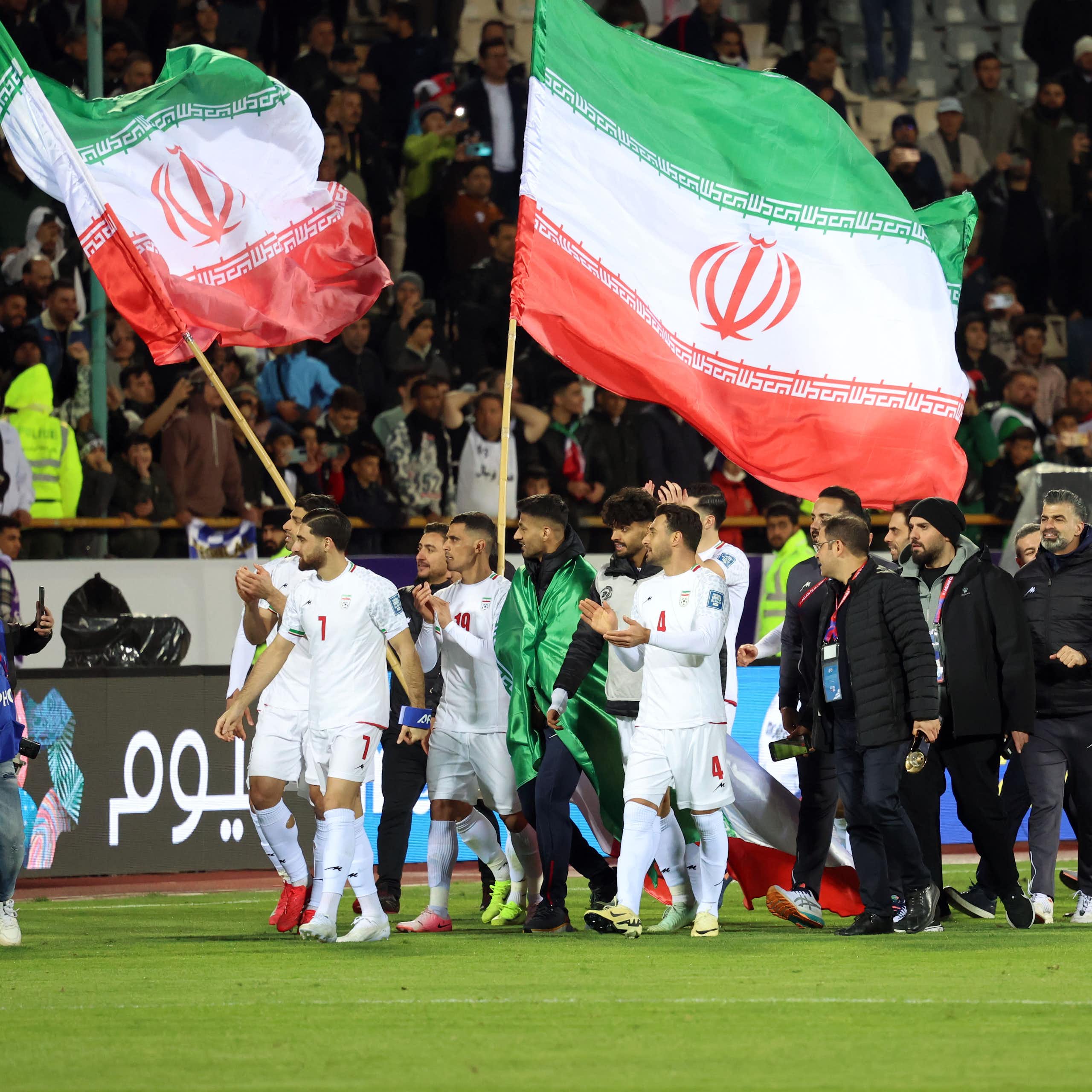 Iran players and staff celebrate after qualifying for the FIFA World Cup.