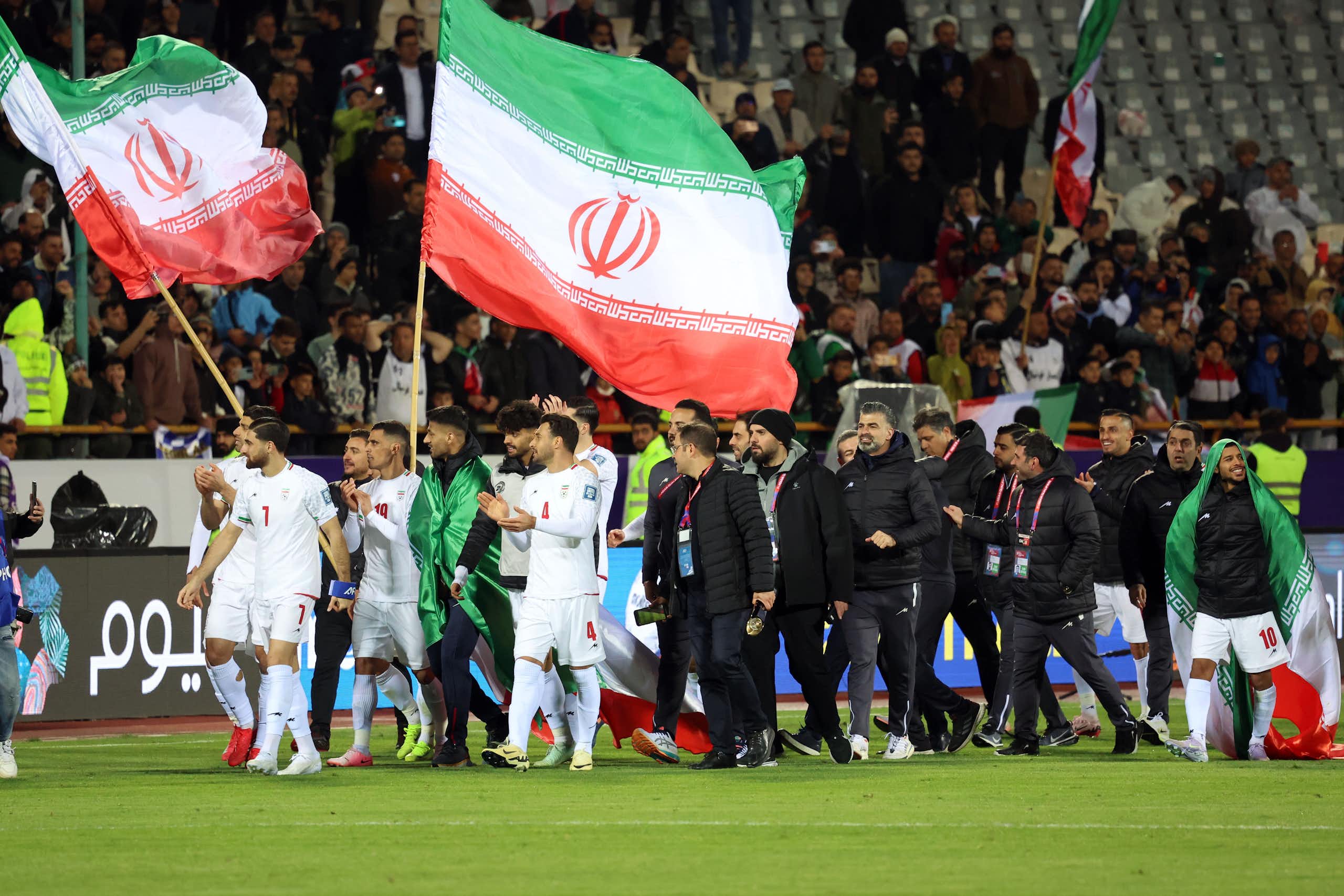 Iran players and staff celebrate after qualifying for the FIFA World Cup.