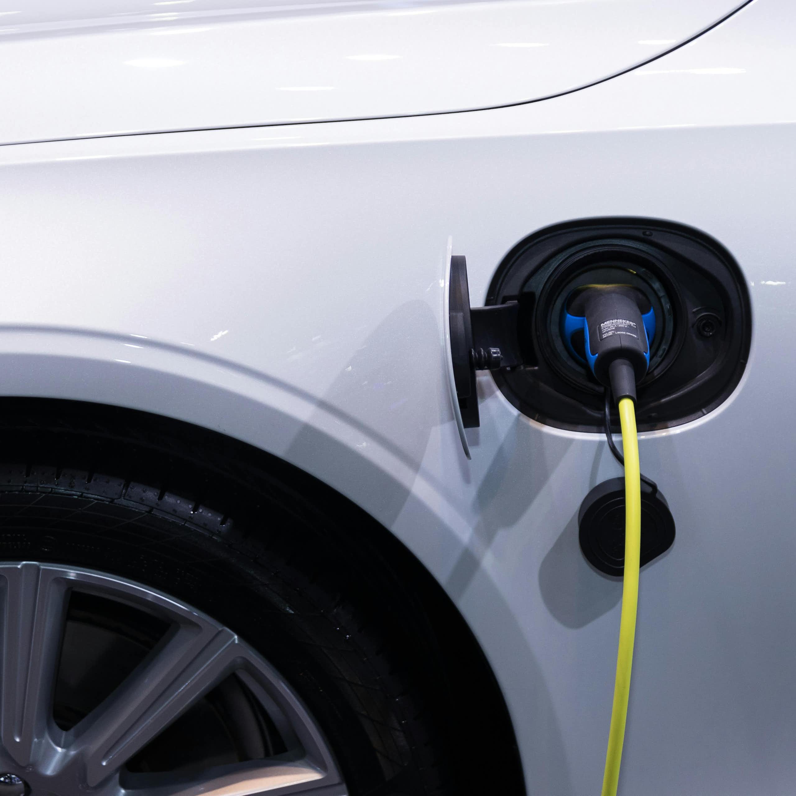 A charging plug going into an EV.