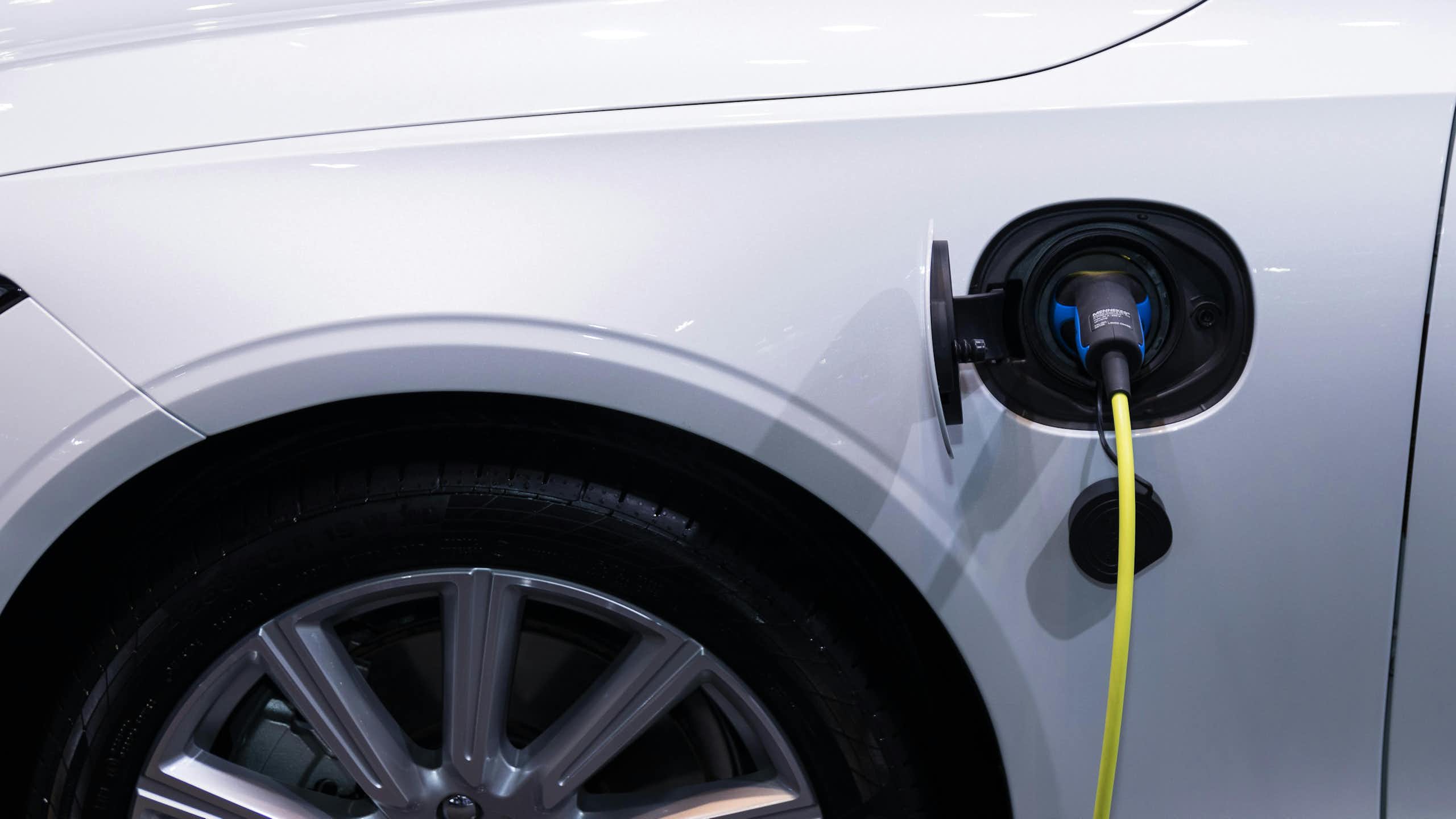 A charging plug going into an EV.