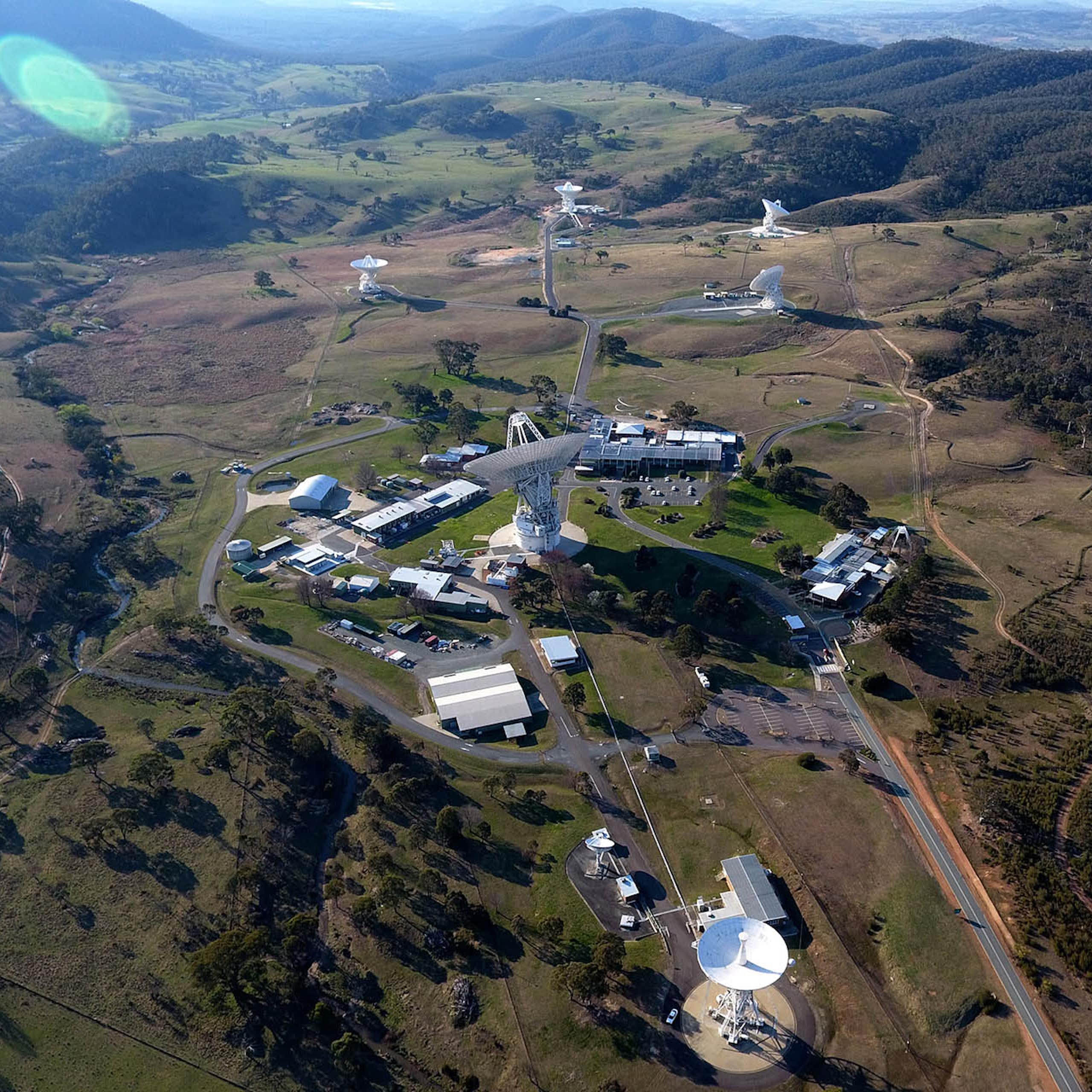 Aerial view of an Australian landscape with space signal dishes and support buildings.