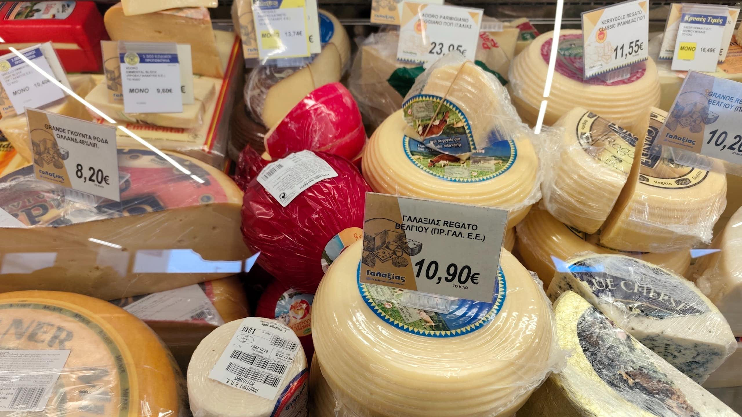 selection of cheeses on a deli counter at a greek supermarket